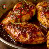 A pan of chicken with honey and garlic.