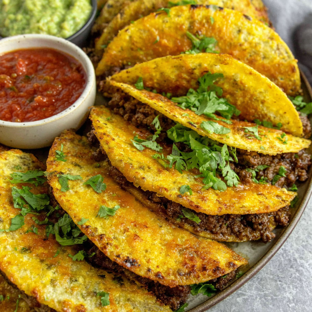 A plate of crispy ground beef tacos.