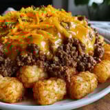 A plate of food with a tater tot casserole and ground beef.