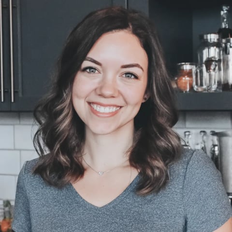 Sarah smiling in front of a kitchen counter.
