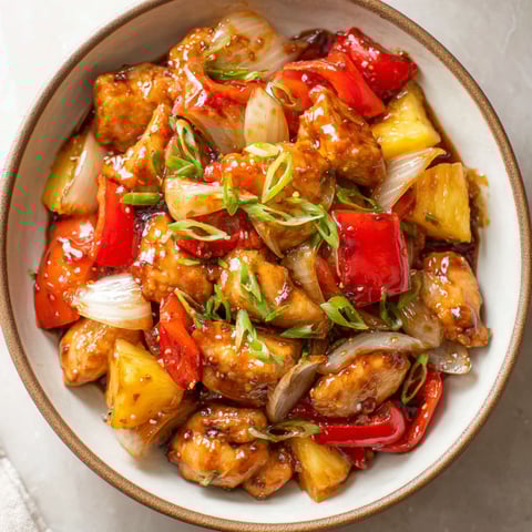 A bowl of pineapple chicken.